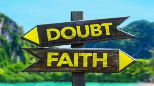 Doubt - Faith signpost in a beach background